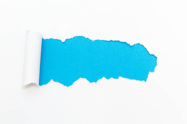 Blue hole in white paper. Empty space for text. - Фото, изображение