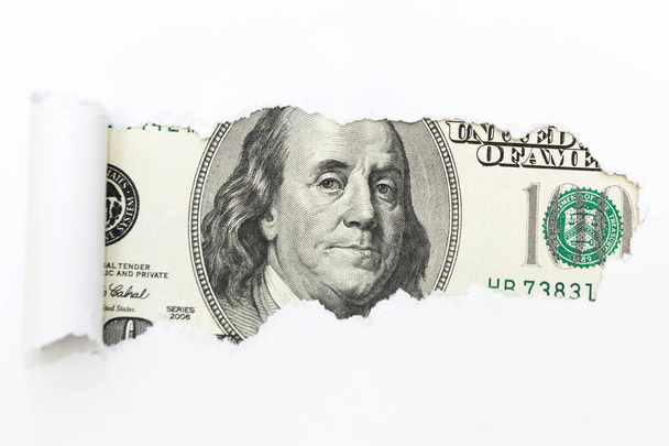 A hundred-dollar bill in a white background rupture. A hole in a white background. Hidden money, tax evasion. - Fotoğraf, Görsel