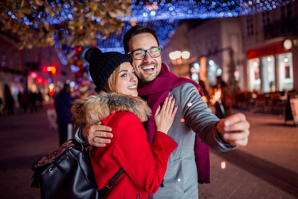 Cute couple enjoy spending time together in New Years Eve. - Photo, Image
