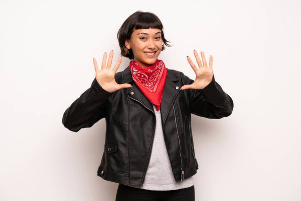 Mujer con chaqueta de cuero y pañuelo contando diez con los dedos
 - Foto, imagen