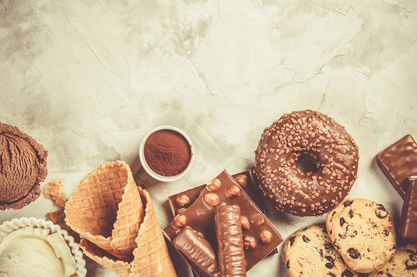 Selection of chocolate sweets - donut, ice cream, cookies - Foto, afbeelding