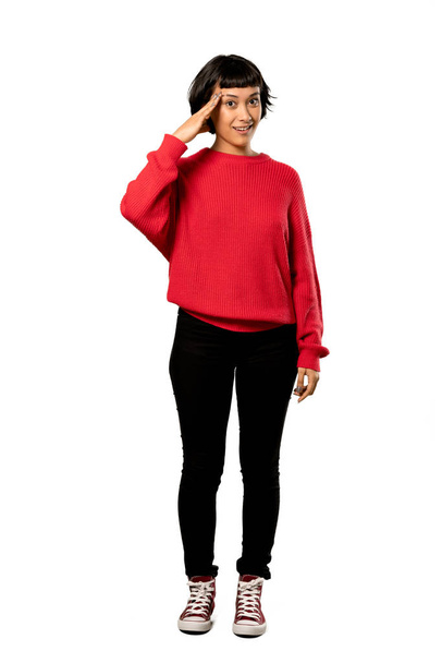 A full-length shot of a Short hair girl with red sweater has just realized something and has intending the solution over isolated white background - Photo, Image