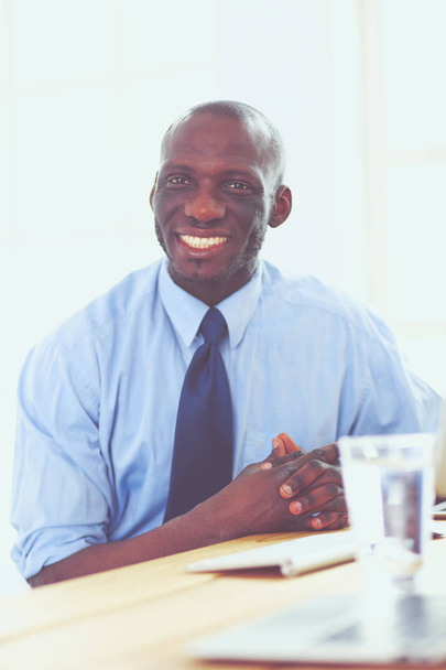 African american businessman on headset working on his laptop - Valokuva, kuva