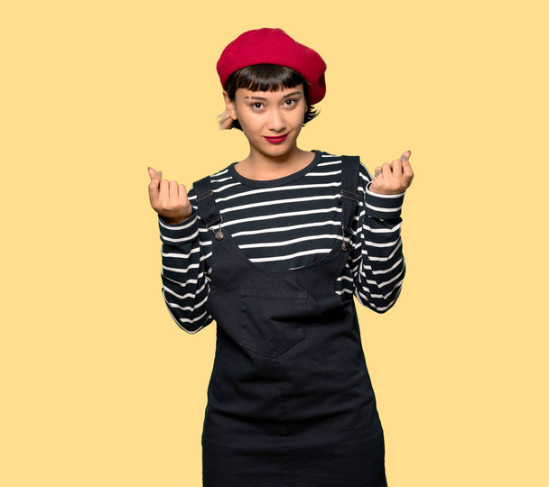 Young woman with beret making money gesture - Photo, Image