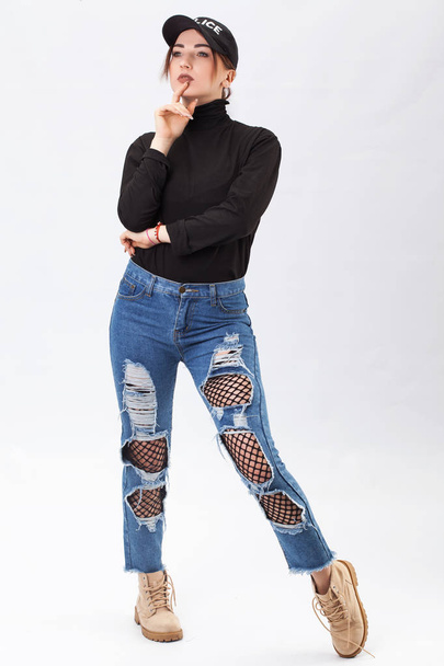 Smiling attractive woman in jeans and blouse posing and looking at camera. Full length studio shot isolated on white. - 写真・画像
