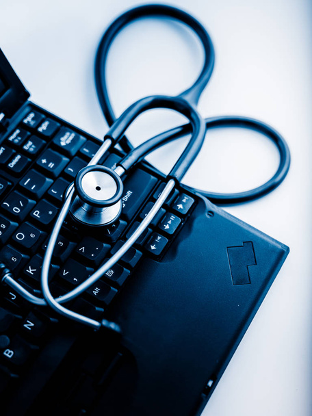 Elektronische medische, stethoscoop op Laptop blauw getinte beelden. - Foto, afbeelding