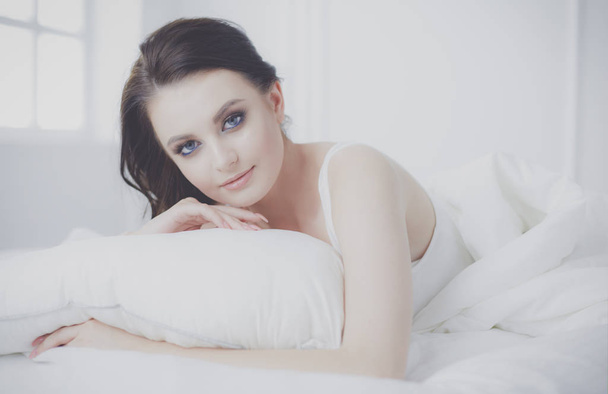Young beautiful woman lying in bed. - Fotó, kép