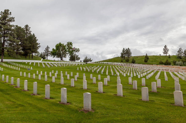 Des rangées de pierres tombales en marbre blanc marquent les tombes de soldats américains sur le flanc de la colline du cimetière national de Hot Springs dans le Dakota du Sud
. - Photo, image