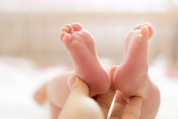 Baby feet in mother hands. Mom and her Child. Happy Family concept. Beautiful conceptual image of Maternity - Φωτογραφία, εικόνα