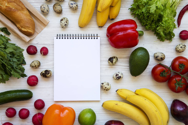 Healthy food concept. Health food with blank notepad on a white wooden surface. Flat lay. Top view. From above. Copy space. - Foto, Bild