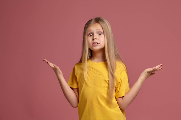 little girl in a yellow t-shirt. throws up her hands - Photo, Image