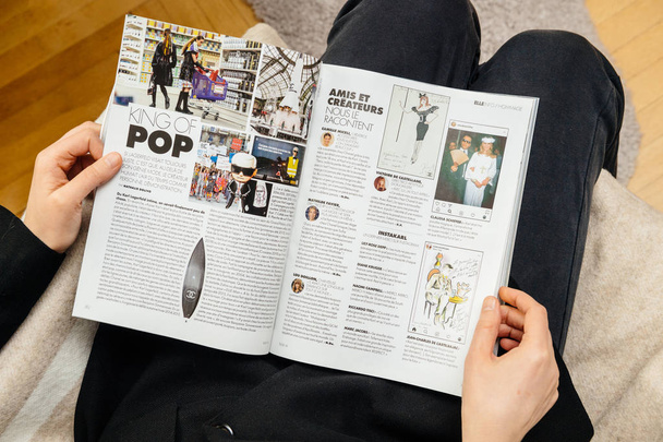 Woman reading newsapepr about Karl Lagerfeld death - Foto, Imagen