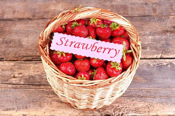 Basket with fresh strawberries on rustic background. - Photo, Image