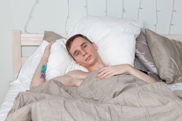 Handsome young adult man sleeping in bed - Fotoğraf, Görsel