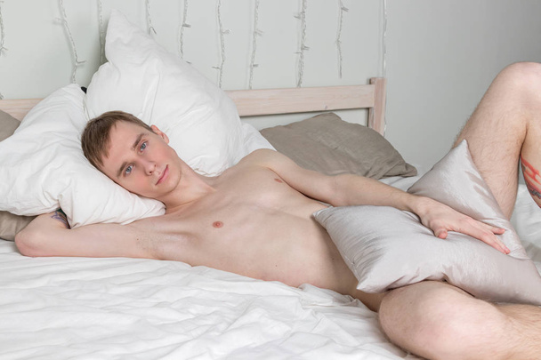Handsome young adult man sleeping in bed - Foto, Imagen