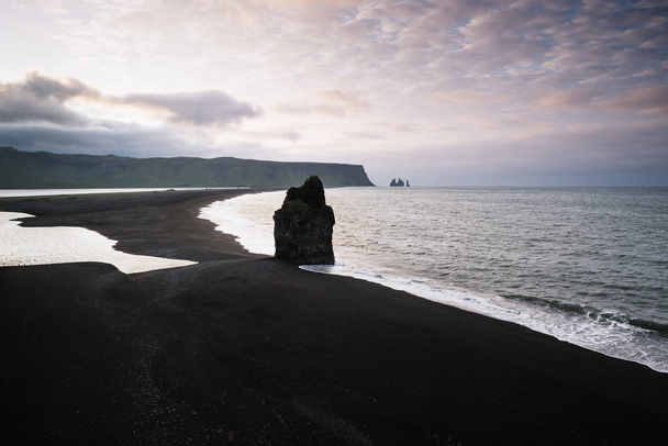 View from cape Dyrholaey on stack Arnardrangur and Reynisdrangar basalt sea stacks. Reynisfjara beach with black volcanic sand. Tourist attraction in the south of Iceland - Fotó, kép