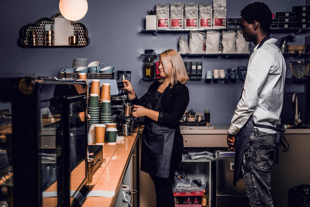 Barista istruisce il nuovo dipendente in una caffetteria
 - Foto, immagini