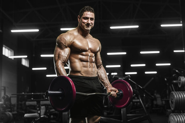 Handsome strong athletic men pumping up muscles workout barbell curl bodybuilding concept background - muscular bodybuilder men doing exercises in gym naked torso - Photo, Image