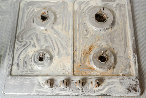 Detergent soap on untidy cooker. Wash with soap kitchen cooking equipment. Top view. - Photo, Image