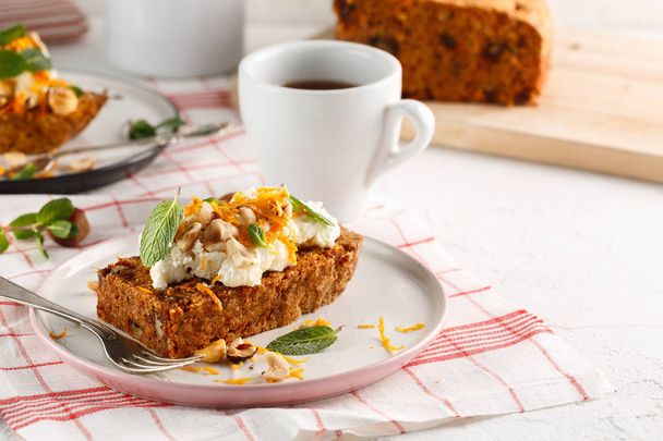 carrot fruit cake, with nuts, cream and mint on white background - Foto, Imagem