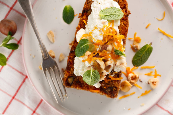 carrot fruit cake, with nuts, cream and mint on white background - Foto, Imagem