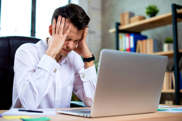 Stressed young businessman shocked by bad news using laptop at work, desperate bankrupt investor lost money, financial problem debt, tired of overwork. - Foto, immagini