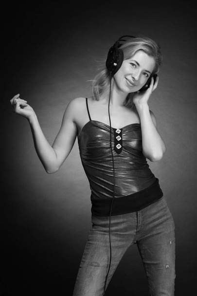 young beautiful girl listening to music on headphones - Φωτογραφία, εικόνα
