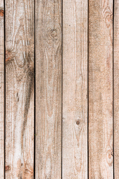 Wooden background. Boards in the sand. Wooden walkway on the sandy beach. Natural materials. The texture of the wooden surface. Beach landscape. - Photo, Image