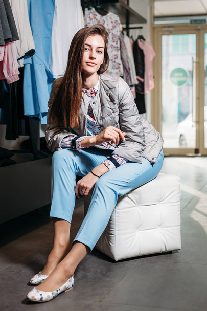 shopping, fashion, style, sale, shopping, business and people. concept beautiful happy young woman in a clothing store. the business owner is a clothing store. businesswoman - Photo, Image
