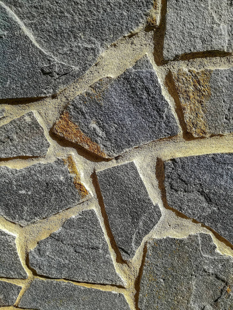 Facade of natural stone and gray cement - Fotoğraf, Görsel