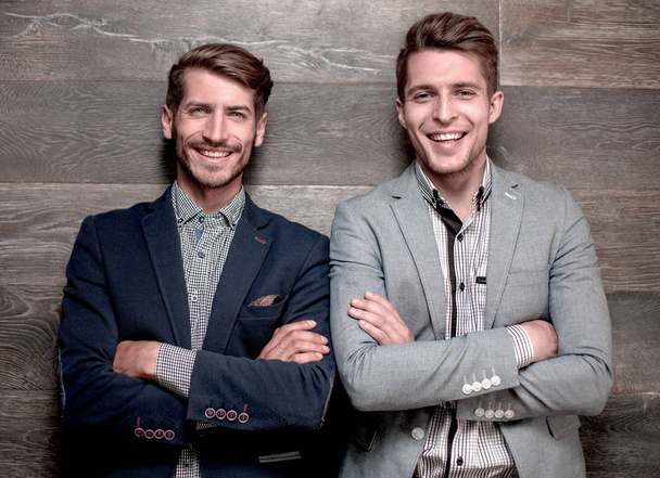 Studio shot of young businessmans together against gray background - Фото, изображение