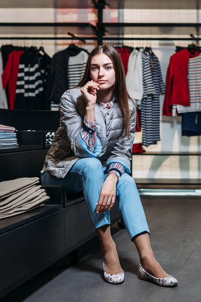 shopping, fashion, style, sale, shopping, business and people. concept beautiful happy young woman in a clothing store. the business owner is a clothing store. businesswoman - Foto, afbeelding