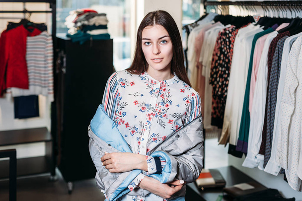 shopping, fashion, style, sale, shopping, business and people. concept beautiful happy young woman in a clothing store. the business owner is a clothing store. businesswoman - Foto, Bild