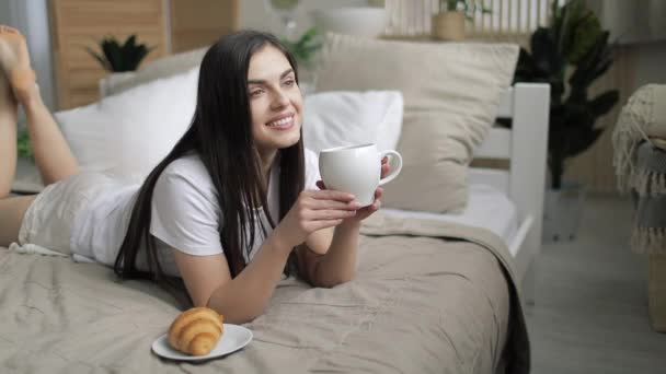 Young Woman Drinking Coffee in Bed - Filmati, video
