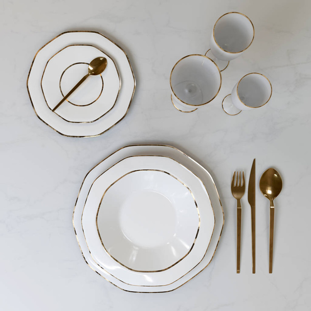 A beautiful set of dishes with a gold pattern. Plates, glasses, spoons, fork, knife on the table. 3D illustration. - Fotografie, Obrázek
