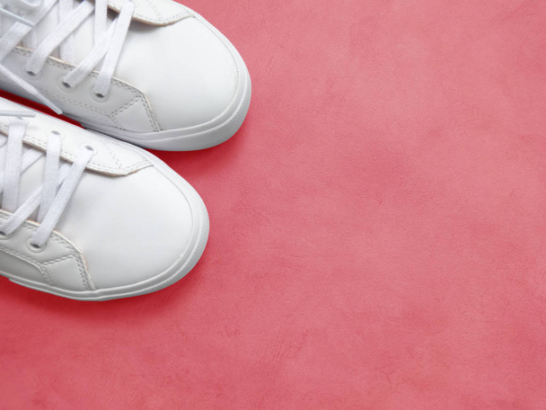 White Women's Sport Shoes on a Pink Background - Foto, Imagen