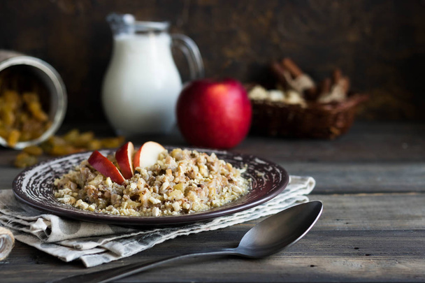 Buckwheat porridge with apples, raisins and cashew nuts for breakfast - 写真・画像