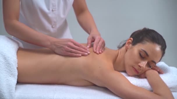 Young woman in spa. Traditional healing therapy and massaging treatments. Health, skin care, massage, osteopathy and recreation concept. - Felvétel, videó