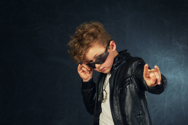 Studio portrait of a stylish boy in a leather jacket . - Φωτογραφία, εικόνα