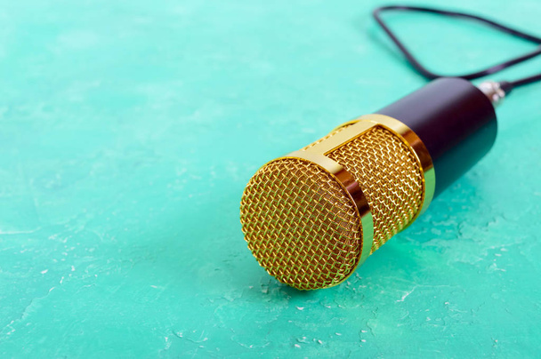 Όμορφη χρυσή μικρόφωνο σε ένα φωτεινό υπόβαθρο, διάστημα αντίγραφο, εσωτερικη, bokeh. - Φωτογραφία, εικόνα