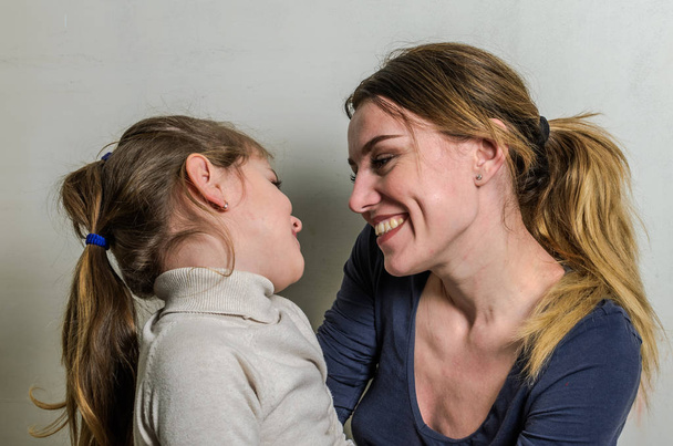 Young charming mother plays with her daughter - happy family - Photo, Image