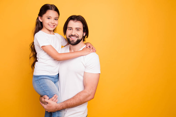 Portrait of her she his he nice adorable cute sweet lovely attractive cheerful people daddy holding in hands pre-teen girl spend time isolated on shine vivid pastel yellow background - Foto, Imagen