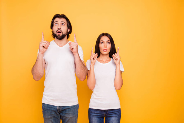 Portrait of her she his he nice attractive lovely cheerful funny caucasian people married spouses pointing up question ask isolated over shine vivid pastel yellow background - Foto, Bild