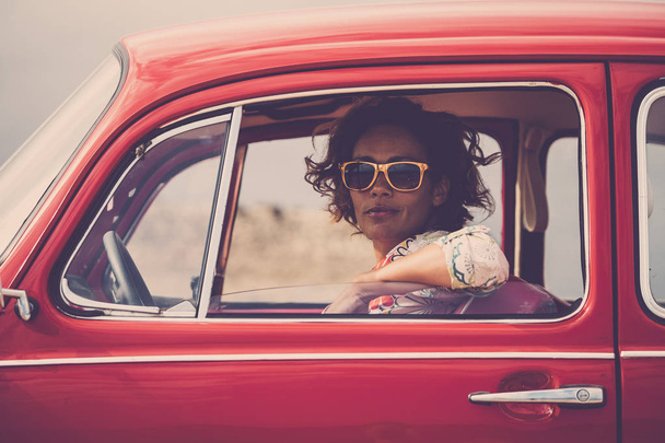 middle age lady driver posing inside of red legendary retro vintage car - Photo, Image