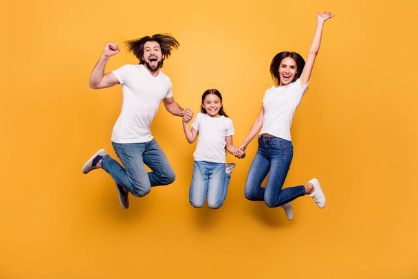 Full length body size portrait of nice lovely charming attractive positive cheerful people dad mom spending free time holding hands isolated over shine vivid pastel yellow background - Fotoğraf, Görsel
