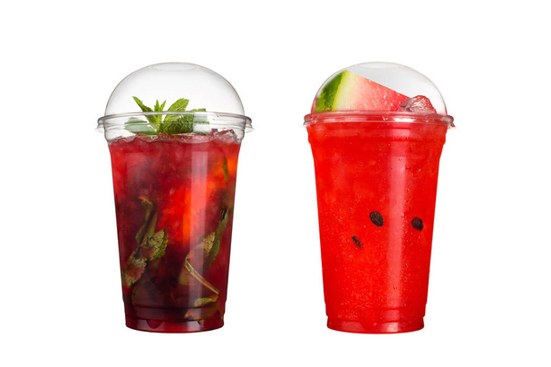 Delicious fruit smoothies in plastic cups, on a white background. Two cocktails with berry and watermelon flavors. Isolated. - Φωτογραφία, εικόνα