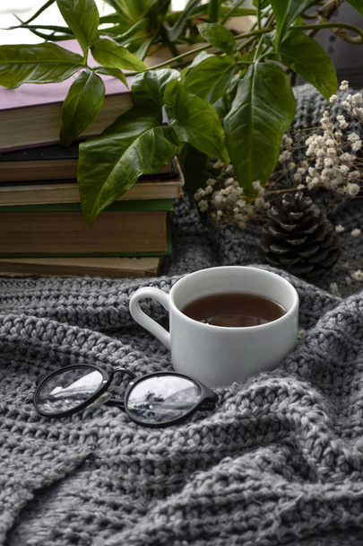 coffee and books on a cozy blanket with flowers - Fotó, kép