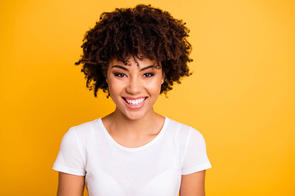 Close up photo beautiful amazing she her dark skin lady toothy beaming smiling optimistic wavy curly pretty wear casual white t-shirt isolated yellow bright vibrant vivid background - Foto, imagen