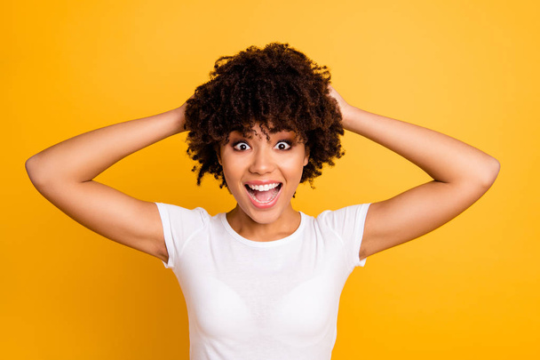 Close up photo beautiful amazing she her dark skin lady arms in hair curly wavy yelling sale discount laugh laughter wearing casual white t-shirt isolated yellow bright vivid background - Photo, image