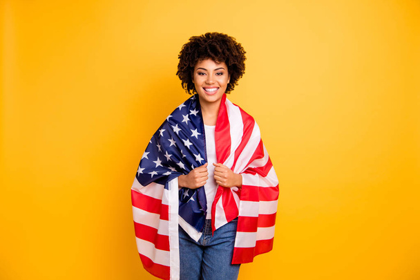 Close up photo beautiful amazing she her dark skin lady hands arms hold american flag best country party 4th of july wearing casual jeans denim white t-shirt isolated yellow bright vibrant background - Foto, immagini
